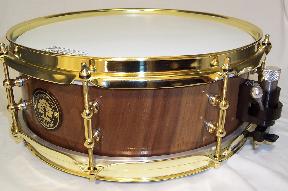 black walnut solid lathed snare with brass tube lugs and black on chrome trick throw-off