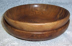 Solid black walnut wood nesting bowls lathed from a solid log that stack one inside another.